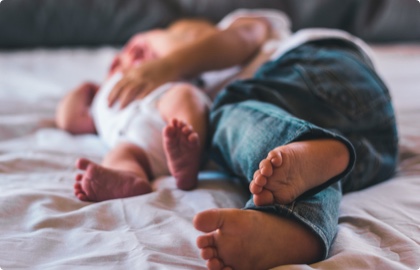 Baby and toddler taking a nap together