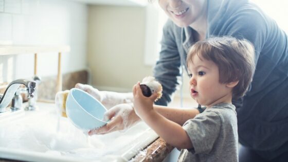 toddler helping Mum in Kitchen