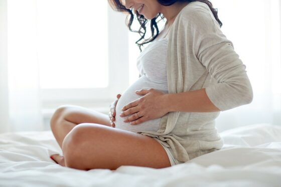 Pregnant women holding her bump