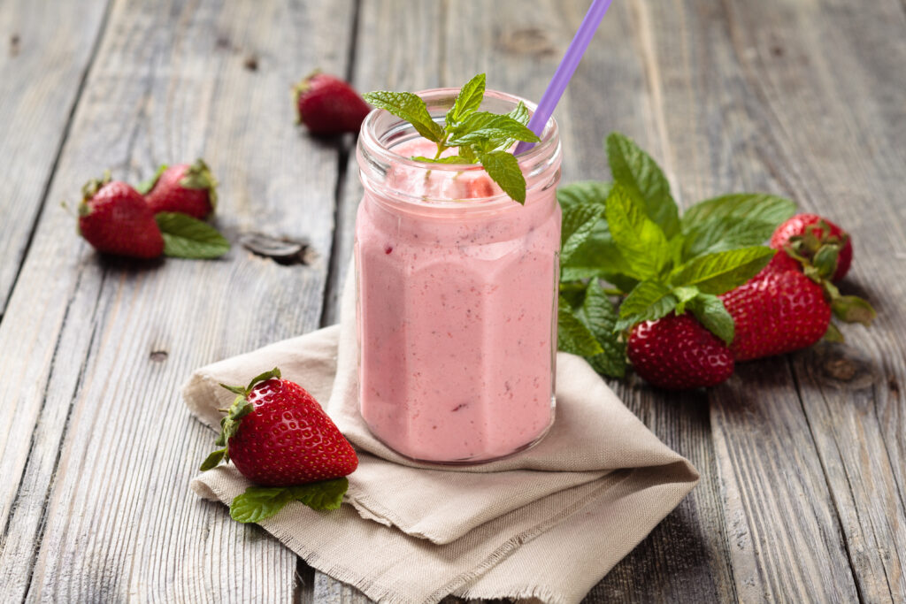 Fortisip Strawberry Recipe: Strawberry Smoothie with mint leaves on wooden rustik table by Nutricia
