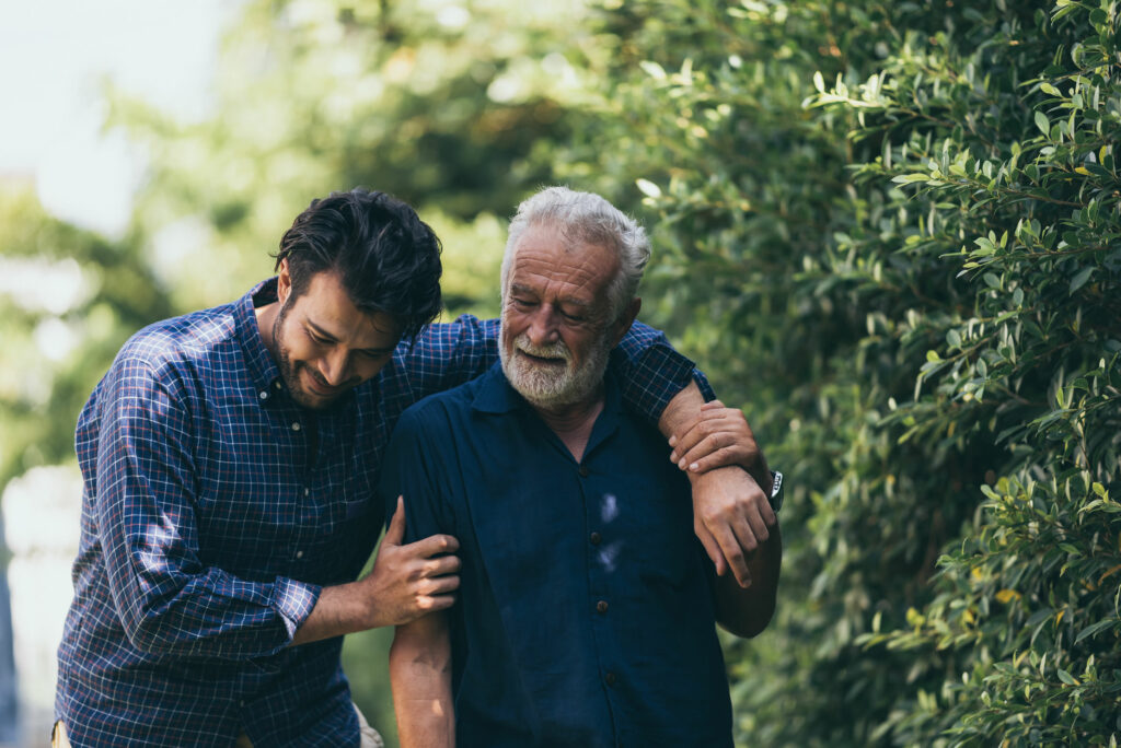 Old man and his son walking in the park
