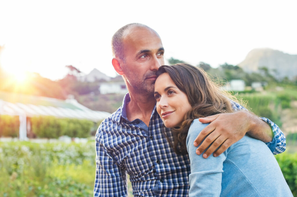 Mature couple hugging in the garden