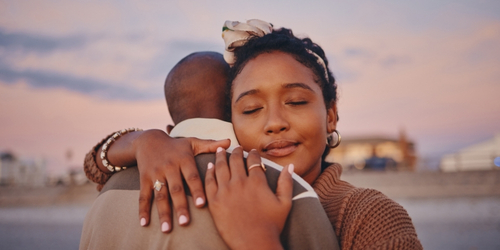 Man and woman embracing at the beach